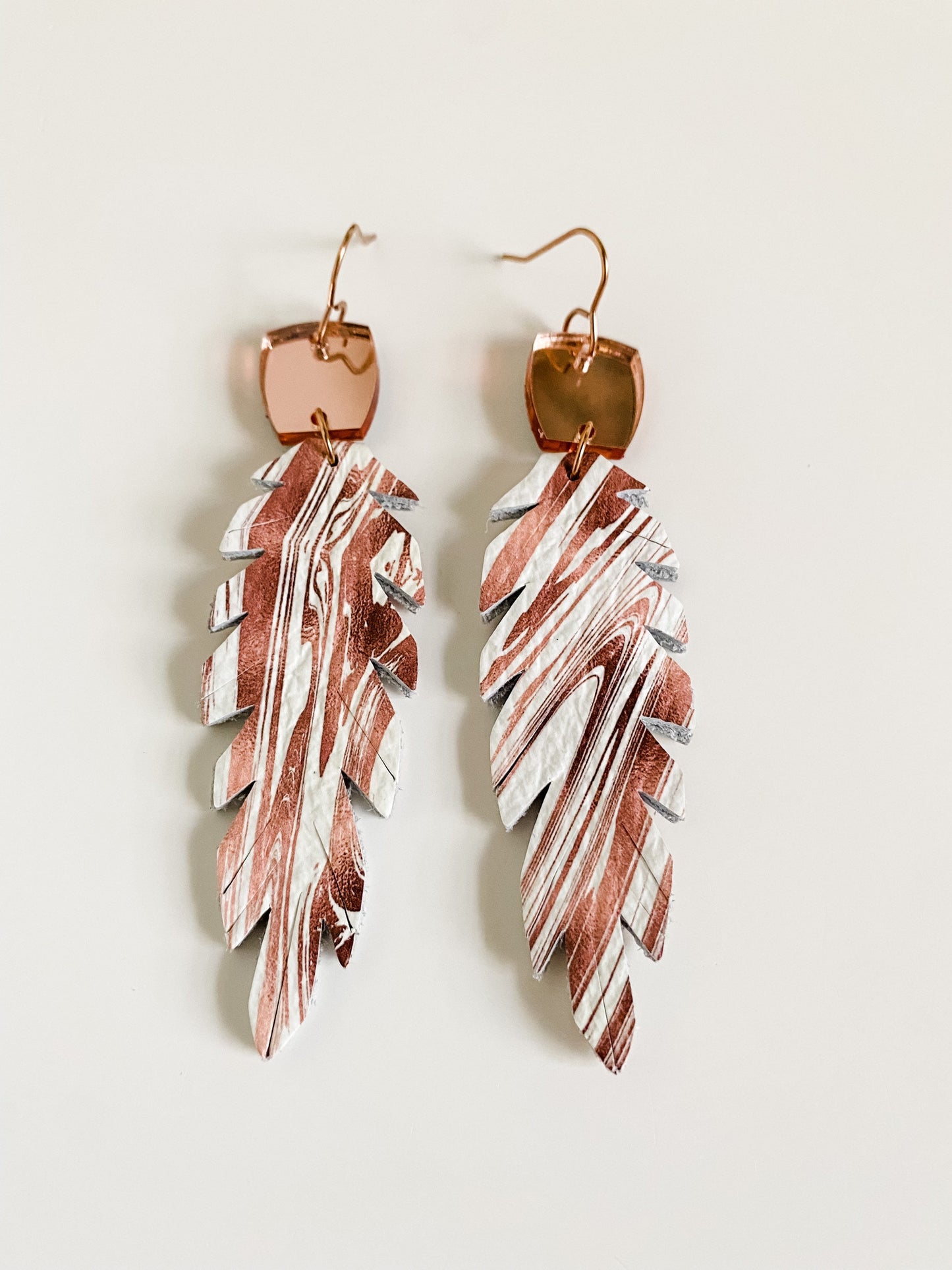 Double Sided Feather Earrings with Mirrored Rose Gold Connectors, Root Beer Swirl on White Leather, Boho Feather Earrings, Medium Length